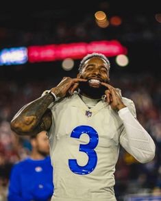 a football player with his hands on his face and the number three written in front of him