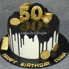 a black and white birthday cake with gold decorations on the top that says 50 years by vivieme