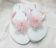 These beautiful flip flops are wrapped in pink satin ribbon, and adorned with an organza ribbon flower with a rhinestone starfish. Ribbon color is pink  if you are needing other colors of ribbon or decoration please contact me and will be happy to accommodate you! All flip flops are handmade to order and the production time 1 to 2 weeks and then please allow additional time for shipping. Amazing for beach, weddings, flower girl or a fancy event, you choose! Please choose your size from the drop Adjustable Pink Sandals For Wedding, Pink Round Toe Flip Flops For Party, Pink Wedding Sandals, Girls Wedding Shoes, Bridal Flip Flops, Pink Flip Flops, White Flip Flops, Flower Sandals, Organza Flowers