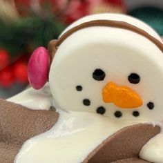 a close up of a snowman cake with icing on it's head