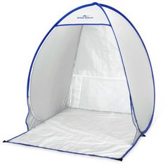 a white tent with blue trim on the front and side walls, open to reveal a bed inside