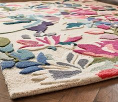 an area rug with flowers and leaves on it