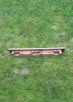 a wooden bench sitting on top of a lush green field