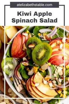 a white bowl filled with apples, kiwi and spinach salad on top of a table