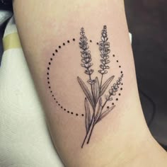 a tattoo on the leg of a woman with lavenders in it's center