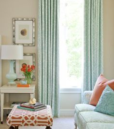 an image of a living room with blue and orange decor on the couches, coffee table