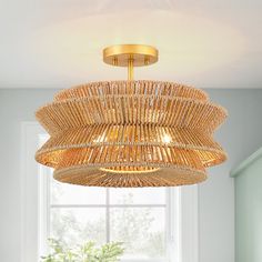 a dining room table and chairs with a large bamboo chandelier hanging from the ceiling