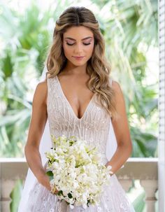 a woman in a wedding dress holding a bouquet