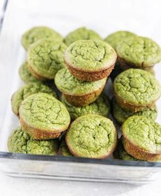 green muffins in a glass dish on a table