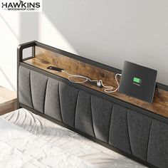 an electronic device is plugged into the side of a bed with headboard and foot board