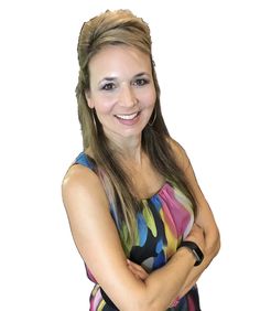 a woman with her arms crossed posing for a photo in front of a white background