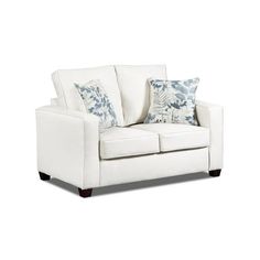 a white couch with blue and white pillows on top of it's armrests