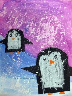 two penguins are standing in the snow