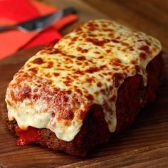 a piece of meatloaf with cheese and sauce on it