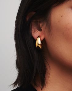 Dome Medium Hoop Earrings | 18k Gold Plated. These Sculptural Medium-Sized Chunky Hoops Feature an Organic-Inspired Domed Design. Handcrafted for Everyday Wear, the Earrings are Super Lightweight and Feature a High-Shine Finish. Pair with Domed Huggies to Create a Scaled Hoop Ear Stack. Metal: 18K Recycled Gold Plating on Brass Dimensions: 25. 8mm X 11. 3mm Weight: 13g Product Code: Dm-G-E5-Ns Timeless Tarnish-resistant Huggie Earrings For Formal Occasions, Timeless Tarnish-resistant Huggie Earrings For Formal Events, Timeless Teardrop Earrings With Polished Finish, Timeless Teardrop Polished Earrings, Timeless Teardrop Hoop Earrings As Gift, Teardrop Hoop Earrings With Polished Finish For Formal Occasions, Teardrop Hoop Earrings With Polished Finish For Formal Events, Timeless Gold Teardrop Huggie Earrings, Formal Teardrop Huggie Earrings With Polished Finish