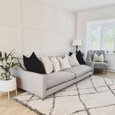 a living room filled with furniture and a white rug