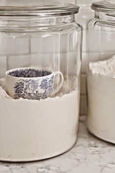 two glass jars filled with white stuff on top of a counter