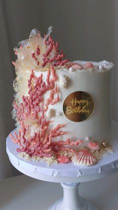 a birthday cake with pink and white decorations