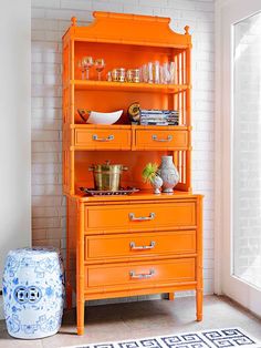 an orange china cabinet in a white room