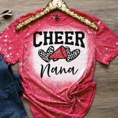 Cheer Nana Red Unisex Bleached Shirt Brand: Gildan Softstyle  Color: Heather Red Available Sizes: Small-4x Available  Ships USPS First Class with tracking Upon receipt of your order please leave a rating as it helps grow my small business and receive funding for the item purchased. Thank you! Pink Short Sleeve Tops With Team Name, Red Fitted Tops For Cheerleading, Fitted Red Tops For Cheerleading, Red Tops With Team Name For School Spirit, Red Team Spirit Tops For Cheerleading, Red Cheerleading Team Tops, Red Top With Sublimation Print And Short Sleeves, Fitted Red T-shirt With Sublimation Print, Red Graphic Print Top For School Spirit