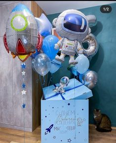 a birthday box with balloons and an astronaut balloon