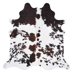 a cowhide rug with brown and white spots