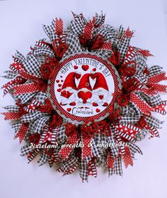 a red and white wreath with hearts on it