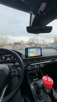 the interior of a car with an electronic device in the dash board and steering wheel