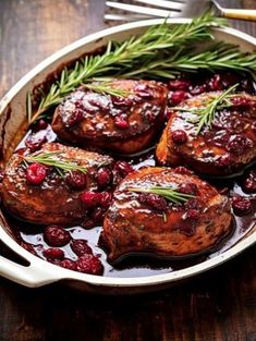 some meat and cranberry sauce in a pan on a table with a fork