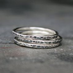 Set of three sterling silver stacking rings.Wear these rings as a regular set of stacking rings, or order a smaller size and wear them as upper finger knuckle rings. Hand formed and hammered.Oxidized, burnished and polished to highlight the texture of the design. When the 3 rings are stacked together they're approx 5mm or 3/16" wide.This set of rings will be handmade to order in your size.  Please select your size from the drop down menu when you check out.Also available with a shiny finish:http Sterling Silver Double Band Stackable Promise Rings, Sterling Silver Stackable Double Band Ring, Silver Stackable Midi Rings With Double Band, Minimalist Stacked Silver Rings, Silver Stackable Double Band Midi Rings, Everyday Silver Stacked Rings, Everyday Stacked Silver Rings, Sterling Silver Stacked Promise Rings, Minimalist Silver Stackable Rings