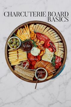 a wooden bowl filled with different types of cheese and crackers on top of a marble counter