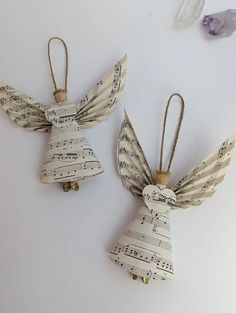 two angel ornaments made out of sheet music