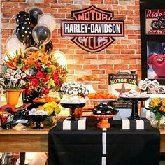 a harley davidson themed birthday party with balloons and decorations on the wall behind the table