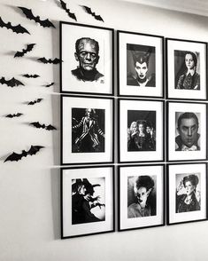 black and white photograph of halloween pictures on the wall with bats hanging from it's sides