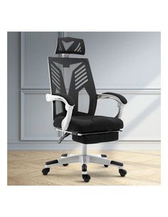 an office chair with black fabric and white frame, in front of a gray wall