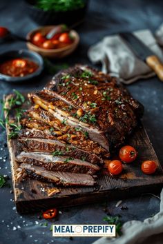 sliced meat on a cutting board with tomatoes and herbs