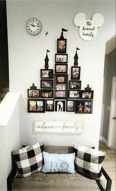 a living room filled with lots of pictures on the wall above a couch covered in pillows