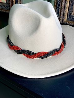 Add a little sparkle to any hat in seconds.  This beautifully hand beaded hat band is fully adjustable to fit any style hat.  The Georgia hat band is an exquisite twisted pattern of black and red crystals that add elegance to your cowboy hat or sun hat!  Hat NOT included. What makes our Hat Bands different? *Adjustable- all of our elastics are removable and adjustable for the perfect fit. *Try our hat bands on your boots too. * Can also be worn as a headband All of our pieces are hand beaded with quality in mind.  Each hat band comes with the removable and adjustable elastic for maximum comfort and usability. People who loved this hat band also loved our Brittany hat band found here: https://www.etsy.com/listing/524577308 Adjustable Cap For Party, Adjustable Party Cap, Adjustable Red Fedora Hat Band, Adjustable White Hat Bands For Party, Adjustable Short Brim Fedora For Parties, Rhinestone Hat Bands For Country Events, Adjustable Rhinestone Hat Bands For Festivals, Adjustable Red Felt Cap, Red Beaded Festival Hat