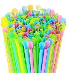 many different colored plastic spoons are stacked together