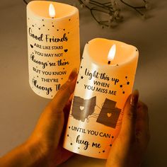 two candles that have been placed next to each other with words on them and one candle is lit