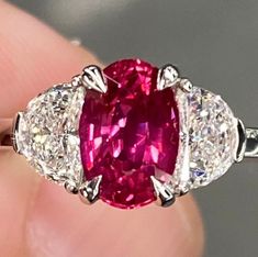 ALL THESE PHOTOS WERE TAKEN WITH AN ORDINARY IPHONE AND HAVE NOT BEEN EDITED OR ENHANCED IN ANY WAY. Up For Sale is a Gorgeous Natural Unheated Vivid Red Ruby & Diamond Three Stone Ring in Solid Platinum. This Ring was Made By Us here in New York City & is Of The Finest Quality. VIDEO LINKS: https://youtube.com/shorts/r21GIIHisR8?feature=share https://youtube.com/shorts/r21GIIHisR8?feature=share The Center Stone is a Super Fine GIA Certified 1.52 Ct Oval Cut Blood Red Natural Ruby that Measures Pink Sapphire Diamond Ring, Golden Rings, Vvs Diamond, Pink Sapphire Ring, Three Stone Engagement, Sapphire Diamond Ring, Engagement Bands, Blood Red, Ruby Diamond