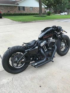 a black motorcycle parked in front of a house