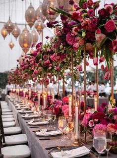 a long table with flowers and candles is set up for a formal dinner or reception