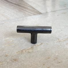 a metal object sitting on top of a white marble floor