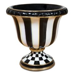 a black and white vase sitting on top of a table