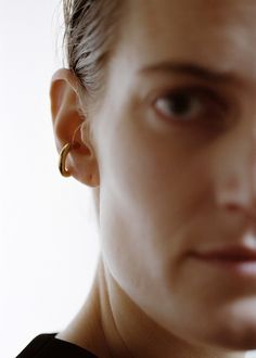 a close up of a person wearing ear rings