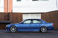 a blue car parked in front of a building