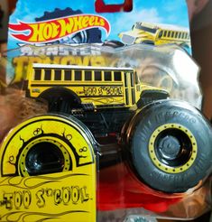 a yellow toy truck with big tires on it's front wheel and the words hot wheels written on its side