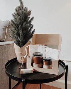 a table with some jars on it next to a christmas tree