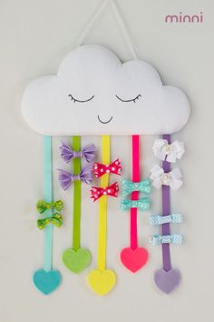 a white cloud with colorful hair clips attached to it